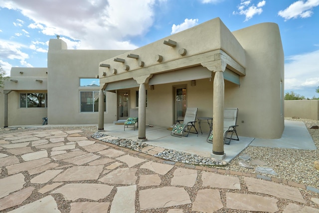 44 Roadrunner Trl, Placitas, NM 87043 - rear view of house featuring stucco siding and a patio