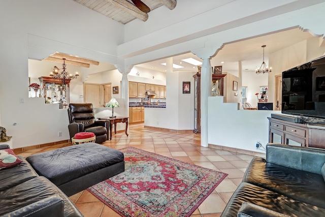 44 Roadrunner Trl, Placitas, NM 87043 - living area featuring decorative columns, a chandelier, beamed ceiling, and light tile patterned flooring