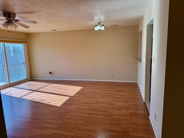 774 Stallion Rd SE, Rio Rancho, NM 87124 - spare room featuring a textured ceiling, wood finished floors, ceiling fan, and baseboards