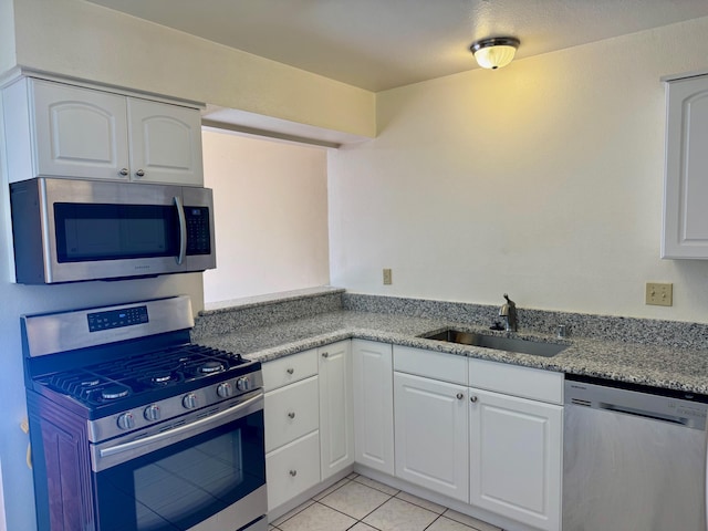 774 Stallion Rd SE, Rio Rancho, NM 87124 - kitchen with appliances with stainless steel finishes, a sink, white cabinets, and light tile patterned flooring