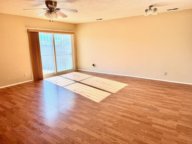 774 Stallion Rd SE, Rio Rancho, NM 87124 - unfurnished room with a textured ceiling, wood finished floors, a ceiling fan, and baseboards