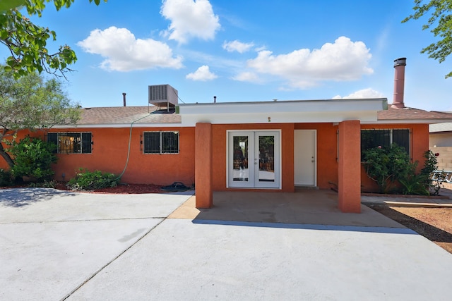 4508 Shiloh Pl NE, Albuquerque, NM 87111 - view of front of house with french doors, stucco siding, and roof with shingles