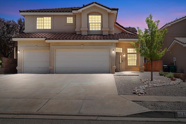 1311 Mirador Loop NE, Rio Rancho, NM 87144 - mediterranean / spanish house featuring a tile roof, a garage, concrete driveway, and stucco siding