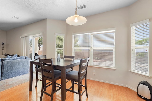 1311 Mirador Loop NE, Rio Rancho, NM 87144 - dining area with light wood-style floors and baseboards