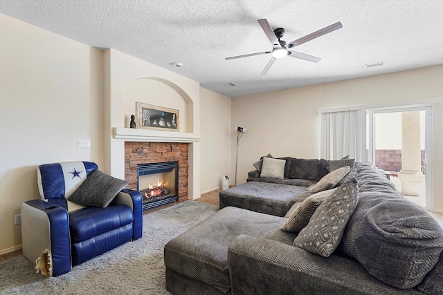 1311 Mirador Loop NE, Rio Rancho, NM 87144 - living area with carpet floors, ceiling fan, a fireplace, a textured ceiling, and baseboards