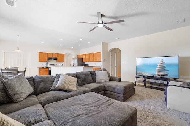 1311 Mirador Loop NE, Rio Rancho, NM 87144 - living room featuring arched walkways, ceiling fan, a textured ceiling, and recessed lighting