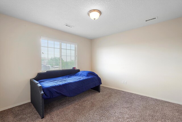 1311 Mirador Loop NE, Rio Rancho, NM 87144 - bedroom featuring carpet, a textured ceiling, and baseboards