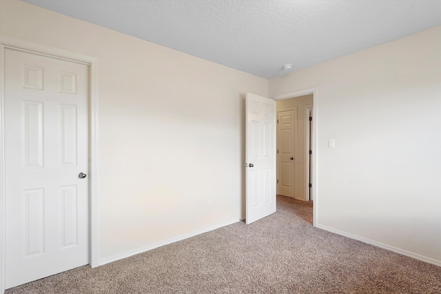 1311 Mirador Loop NE, Rio Rancho, NM 87144 - empty room with light carpet, baseboards, a textured ceiling, and a smoke detector