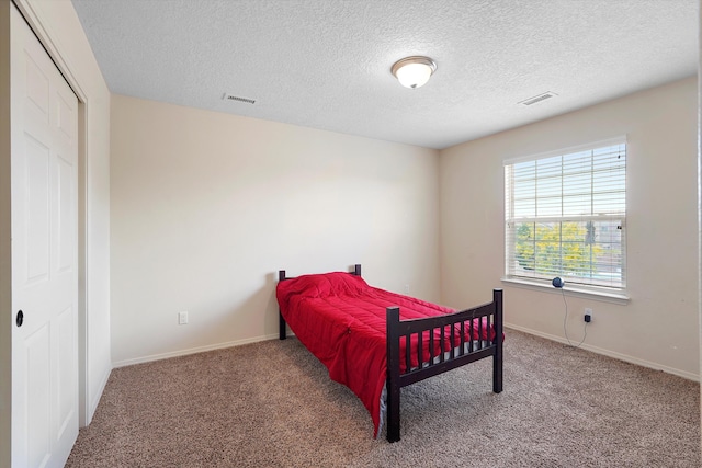 1311 Mirador Loop NE, Rio Rancho, NM 87144 - bedroom with carpet flooring, a textured ceiling, and baseboards