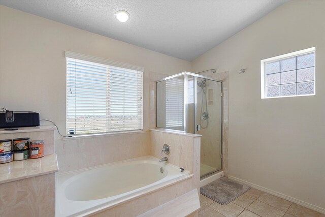 1311 Mirador Loop NE, Rio Rancho, NM 87144 - bathroom featuring healthy amount of natural light, a bath, a shower stall, tile patterned flooring, and a textured ceiling