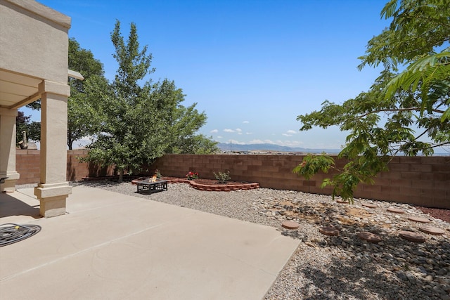 1311 Mirador Loop NE, Rio Rancho, NM 87144 - fenced backyard with an outdoor fire pit and a patio area