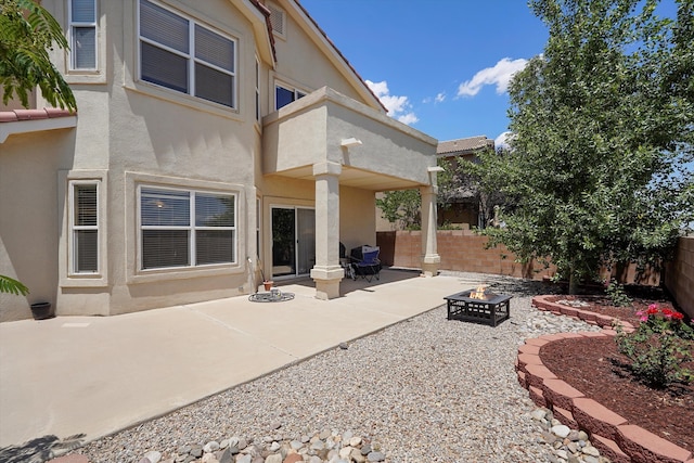 1311 Mirador Loop NE, Rio Rancho, NM 87144 - rear view of property with a fire pit, stucco siding, a fenced backyard, and a patio area