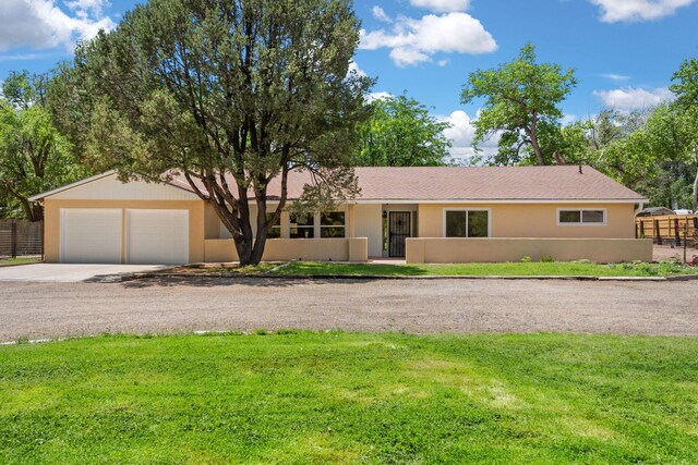 697 W Meadowlark Ln, Corrales, NM 87048 - single story home with concrete driveway and stucco siding