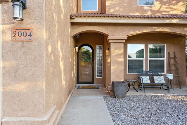 2004 Rancho Oro Ave SE, Rio Rancho, NM 87124 - doorway to property featuring stucco siding