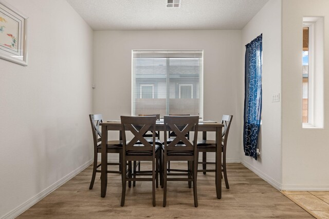 240 Rio Chama Cir SW, Los Lunas, NM 87031 - dining area with wood finished floors, baseboards, and a textured ceiling