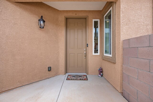 240 Rio Chama Cir SW, Los Lunas, NM 87031 - property entrance with stucco siding