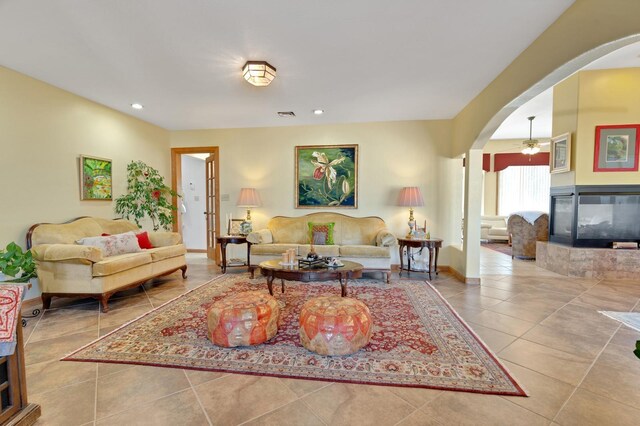 800 Jim St, Socorro, NM 87801 - living room with arched walkways, a tile fireplace, a ceiling fan, tile patterned flooring, and recessed lighting