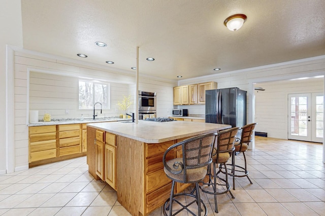 41 El Rancho Grande Rd, Mcintosh, NM 87032 - kitchen with light countertops, appliances with stainless steel finishes, light brown cabinetry, plenty of natural light, and a textured ceiling