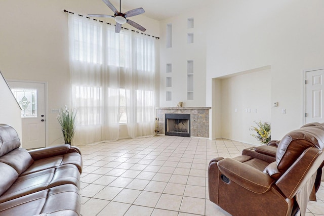41 El Rancho Grande Rd, Mcintosh, NM 87032 - living room with a high ceiling, a ceiling fan, light tile patterned flooring, a fireplace, and built in features