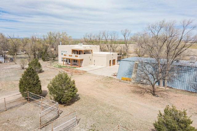 41 El Rancho Grande Rd, Mcintosh, NM 87032 - view of front of house featuring a balcony, a rural view, and stucco siding