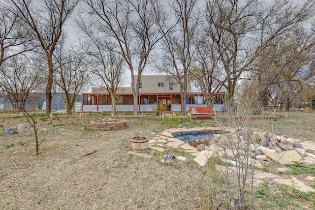 41 El Rancho Grande Rd, Mcintosh, NM 87032 - rear view of property with a sunroom and an outdoor fire pit