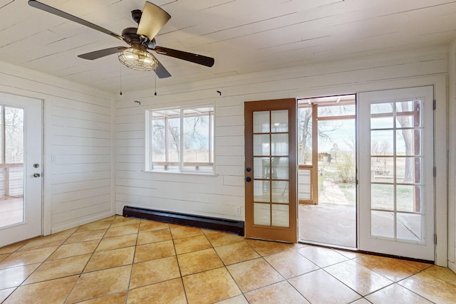 41 El Rancho Grande Rd, Mcintosh, NM 87032 - doorway to outside featuring light tile patterned floors, a baseboard radiator, healthy amount of natural light, and wooden walls