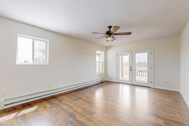 41 El Rancho Grande Rd, Mcintosh, NM 87032 - spare room with baseboard heating, french doors, a ceiling fan, wood finished floors, and a textured ceiling
