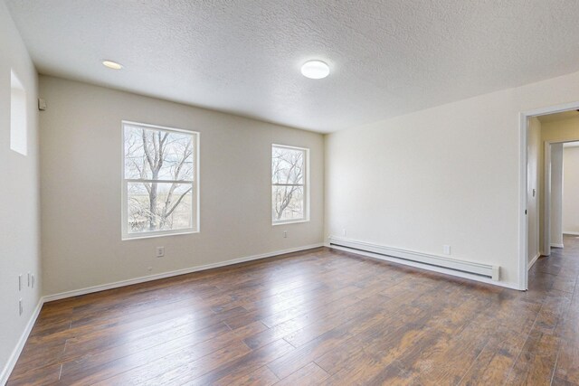 41 El Rancho Grande Rd, Mcintosh, NM 87032 - spare room with a baseboard heating unit, dark wood-type flooring, and a textured ceiling