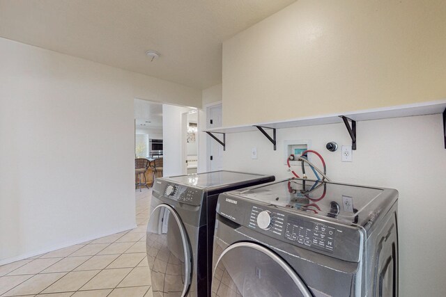 41 El Rancho Grande Rd, Mcintosh, NM 87032 - washroom with washing machine and dryer and light tile patterned floors