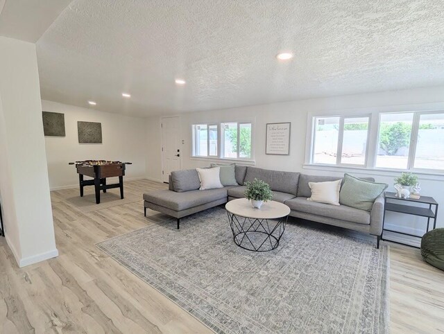 2824 Texas St NE, Albuquerque, NM 87110 - living area featuring light wood finished floors, a textured ceiling, recessed lighting, and baseboards
