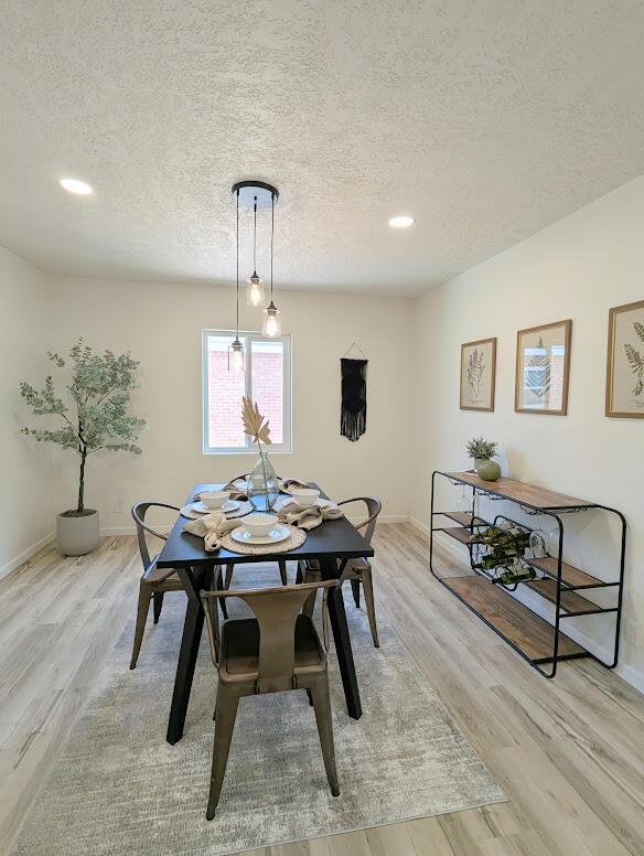 2824 Texas St NE, Albuquerque, NM 87110 - dining space with a textured ceiling, light wood-style flooring, baseboards, and recessed lighting