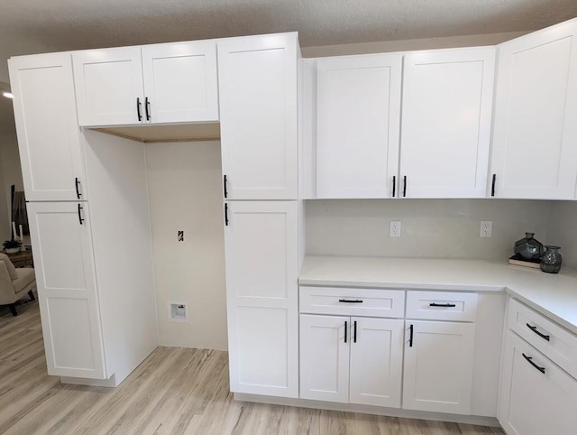 2824 Texas St NE, Albuquerque, NM 87110 - kitchen featuring light wood-style floors, white cabinetry, and light countertops