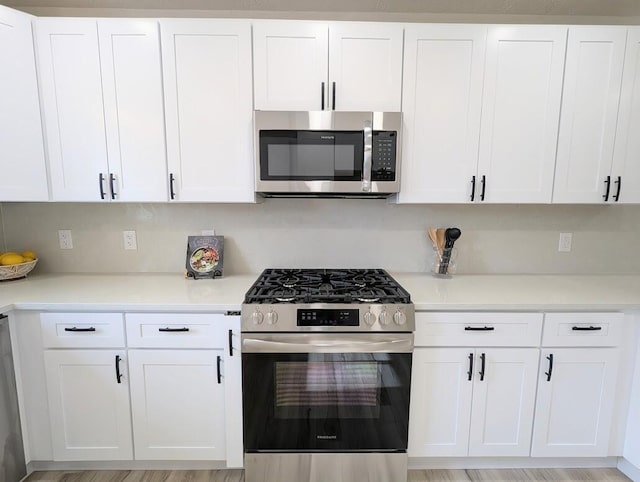 2824 Texas St NE, Albuquerque, NM 87110 - kitchen featuring stainless steel appliances, white cabinets, and light countertops