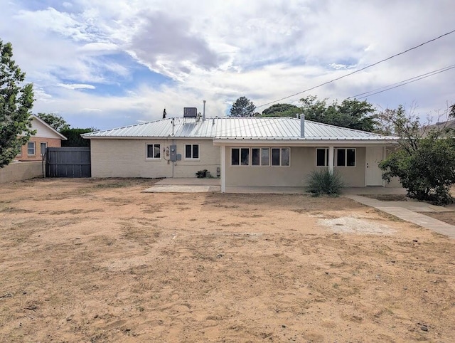 2824 Texas St NE, Albuquerque, NM 87110 - back of property with metal roof, a patio area, and stucco siding