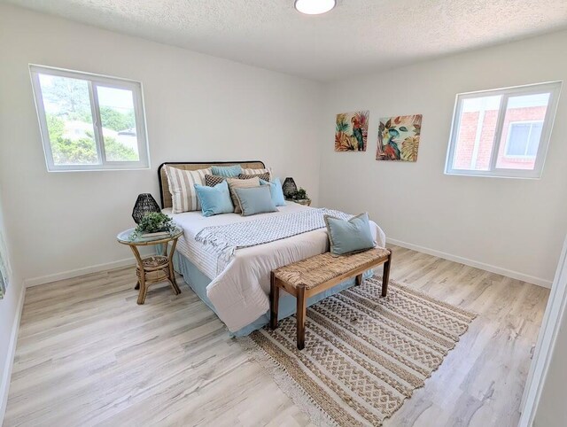 2824 Texas St NE, Albuquerque, NM 87110 - bedroom with wood finished floors, baseboards, and a textured ceiling