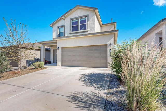 4871 Longs Peak Rd NE, Rio Rancho, NM 87144 - traditional-style house with stucco siding, an attached garage, and driveway