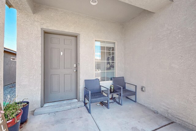 4871 Longs Peak Rd NE, Rio Rancho, NM 87144 - doorway to property featuring stucco siding