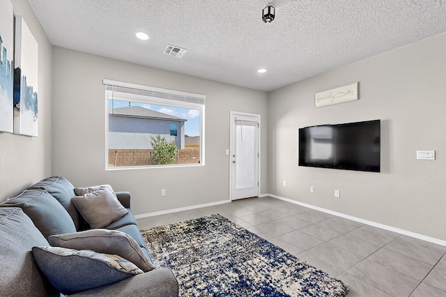 4871 Longs Peak Rd NE, Rio Rancho, NM 87144 - tiled living area with a textured ceiling, recessed lighting, and baseboards