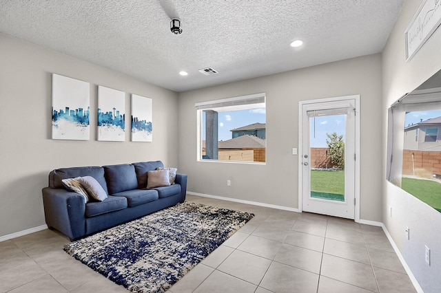 4871 Longs Peak Rd NE, Rio Rancho, NM 87144 - living room with tile patterned floors, recessed lighting, a textured ceiling, and baseboards