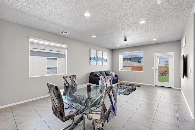 4871 Longs Peak Rd NE, Rio Rancho, NM 87144 - dining area with light tile patterned floors, a textured ceiling, recessed lighting, and baseboards