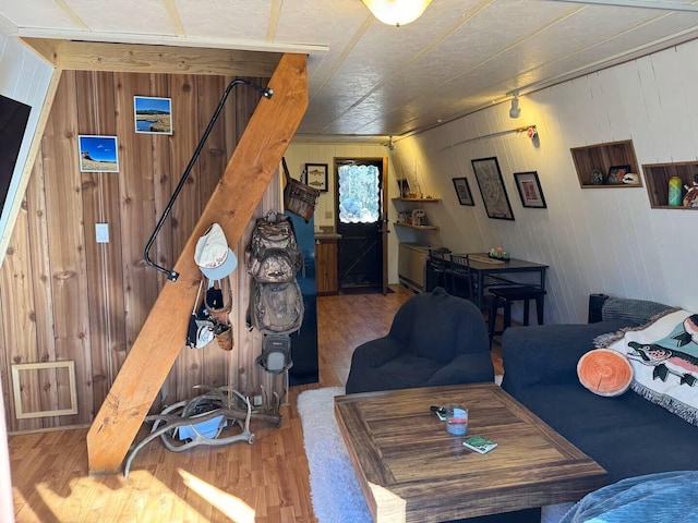 123 Pine Dr, Jemez Springs, NM 87025 - living room featuring wood finished floors, wood walls, and stairway