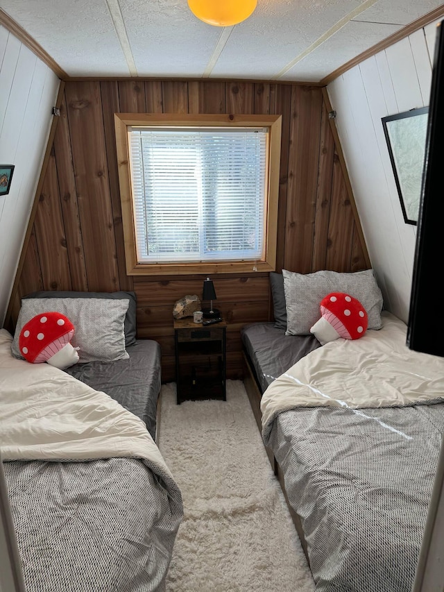 123 Pine Dr, Jemez Springs, NM 87025 - bedroom featuring wooden walls, light carpet, and a textured ceiling