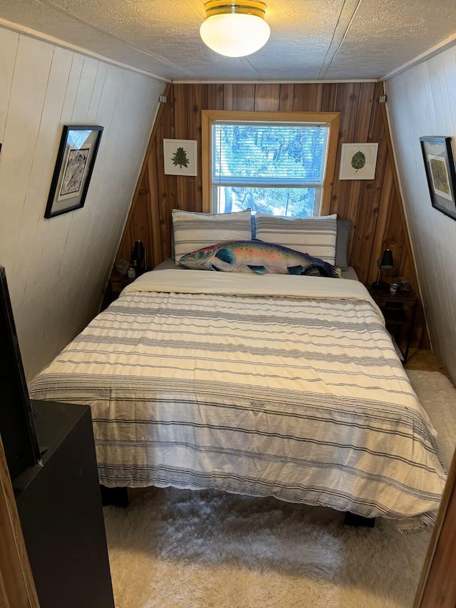 123 Pine Dr, Jemez Springs, NM 87025 - bedroom featuring wood walls, carpet floors, and a textured ceiling