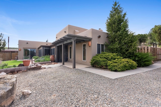 98 Edgewood Unit 7, Edgewood, NM 87015 - back of property featuring a pergola, stucco siding, and a patio area