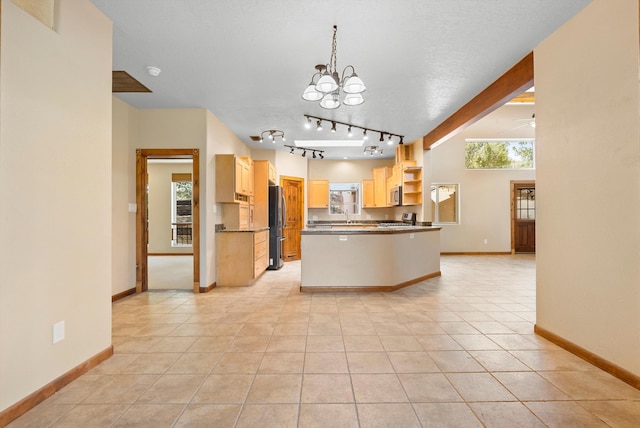 98 Edgewood Unit 7, Edgewood, NM 87015 - kitchen with appliances with stainless steel finishes, healthy amount of natural light, open shelves, and a chandelier