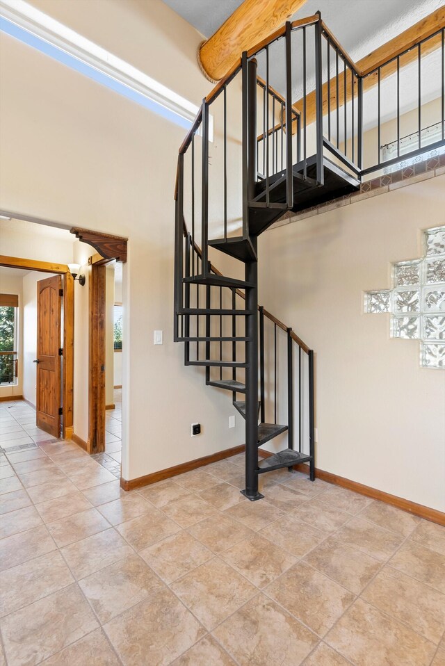 98 Edgewood Unit 7, Edgewood, NM 87015 - stairs with baseboards and tile patterned floors
