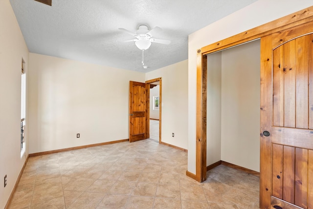 98 Edgewood Unit 7, Edgewood, NM 87015 - unfurnished bedroom featuring a textured ceiling, ceiling fan, and a closet