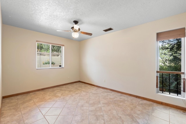 98 Edgewood Unit 7, Edgewood, NM 87015 - unfurnished room featuring a ceiling fan, a textured ceiling, and light tile patterned floors