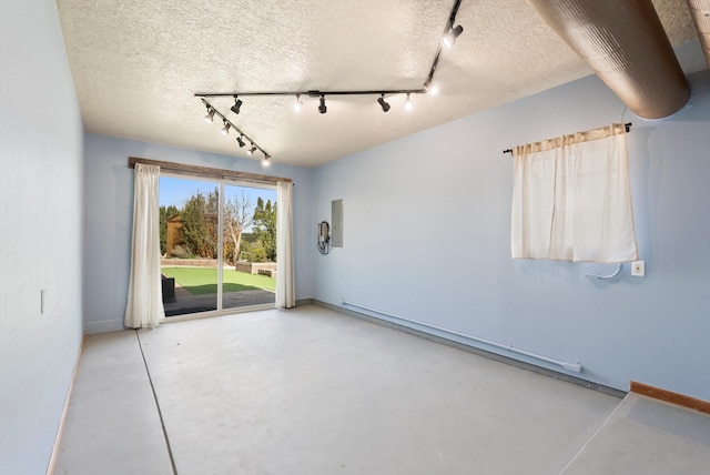 98 Edgewood Unit 7, Edgewood, NM 87015 - empty room featuring concrete floors, track lighting, and a textured ceiling