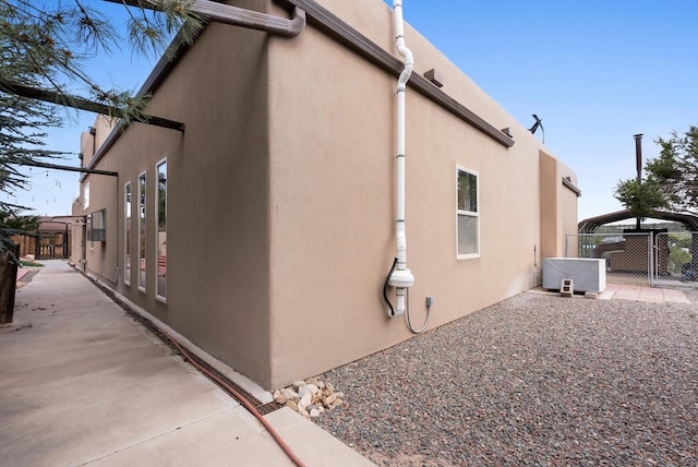 98 Edgewood Unit 7, Edgewood, NM 87015 - view of side of home featuring stucco siding and a gate